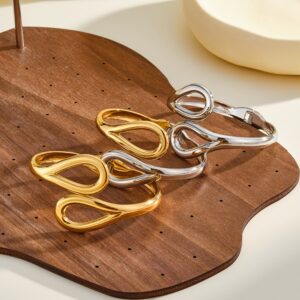 Two‑tone gold and silver 304 stainless steel spring open bangle with intertwined hollow loops, wholesale jewelry